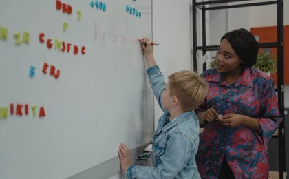 student writing on a whiteboard